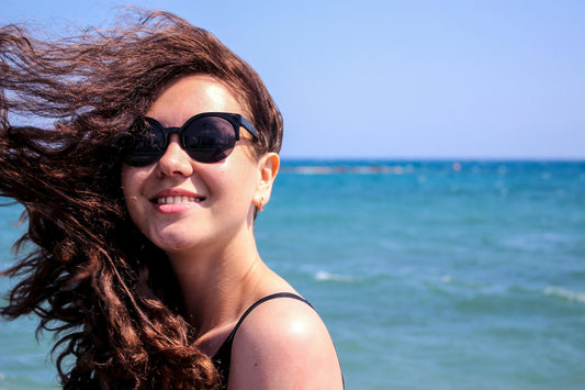 young lady enjoying sunshine at the seaside