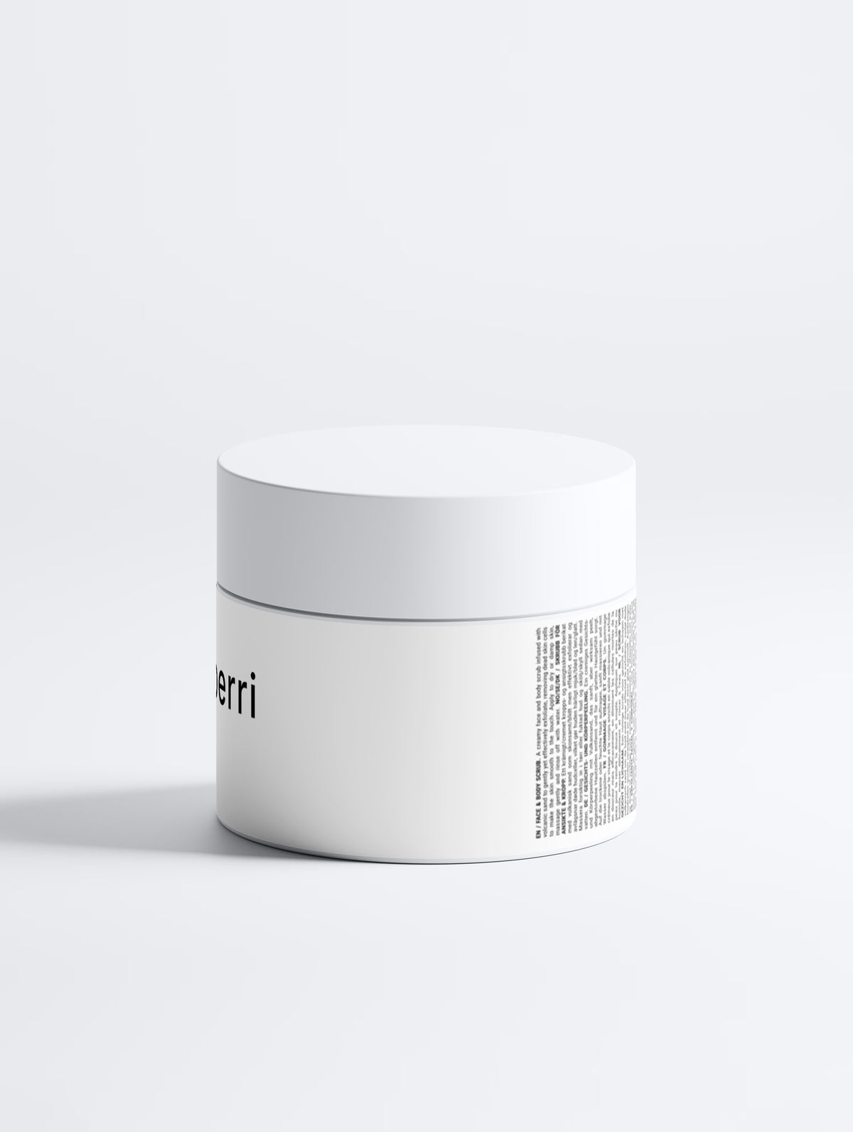 A minimalist matte-white cosmetic jar with a lid sits on a pale grey backdrop, showing a partial “erri” logo and multilingual face-and-body scrub label text.