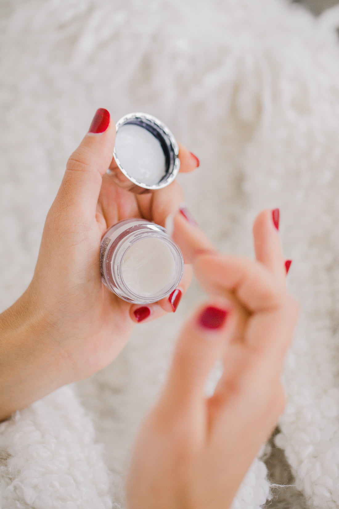 hands of a female applying hand cream