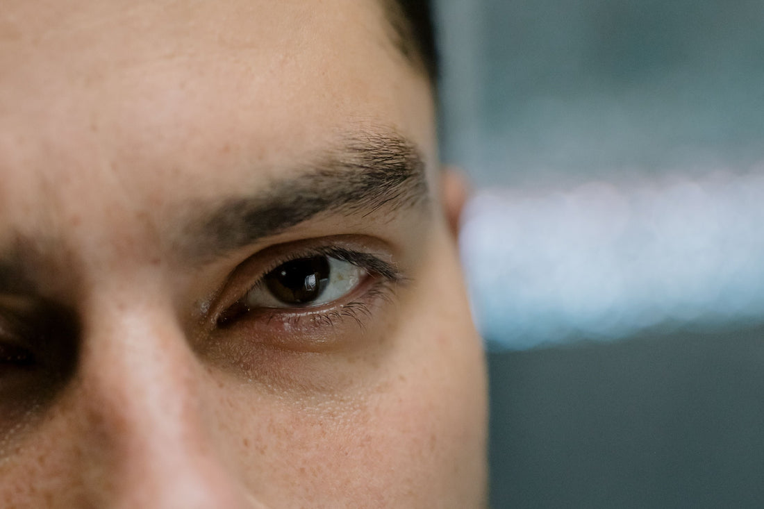 This is a picture of a man focusing on his left eye