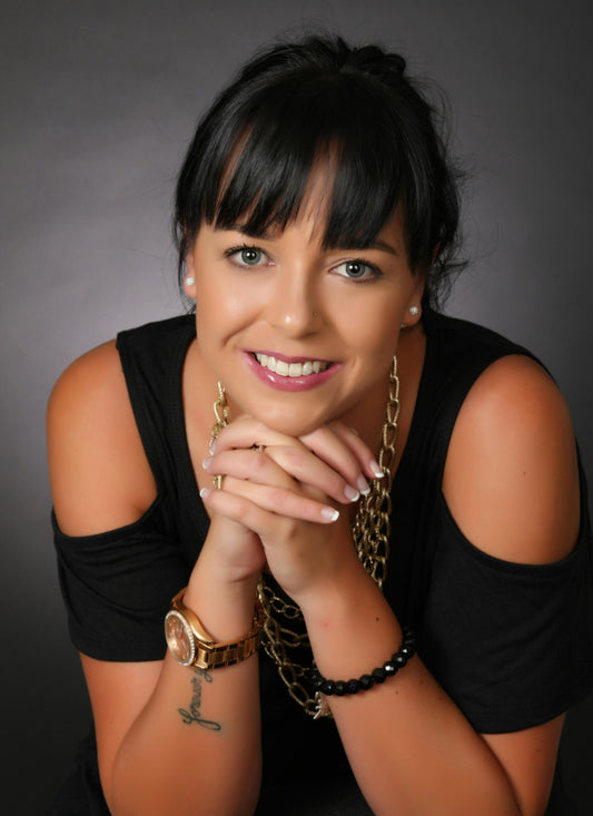 Portrait of a dark-haired young woman in a black dress