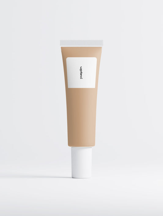 A blank cosmetic tube with a warm beige body, a white rectangular label, and a white cap, centered on a light gray background.