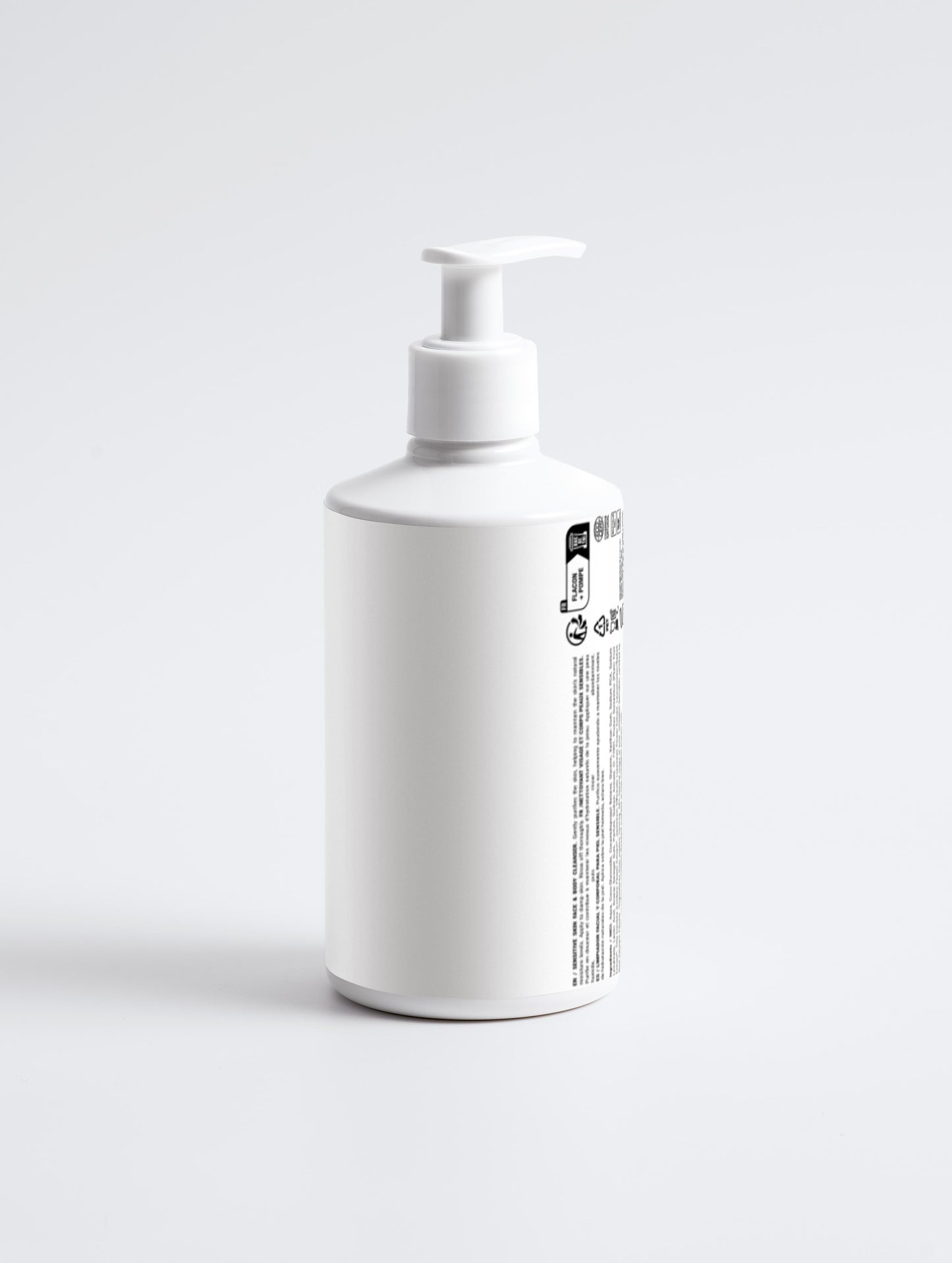 White bottle with pump on a light gray background