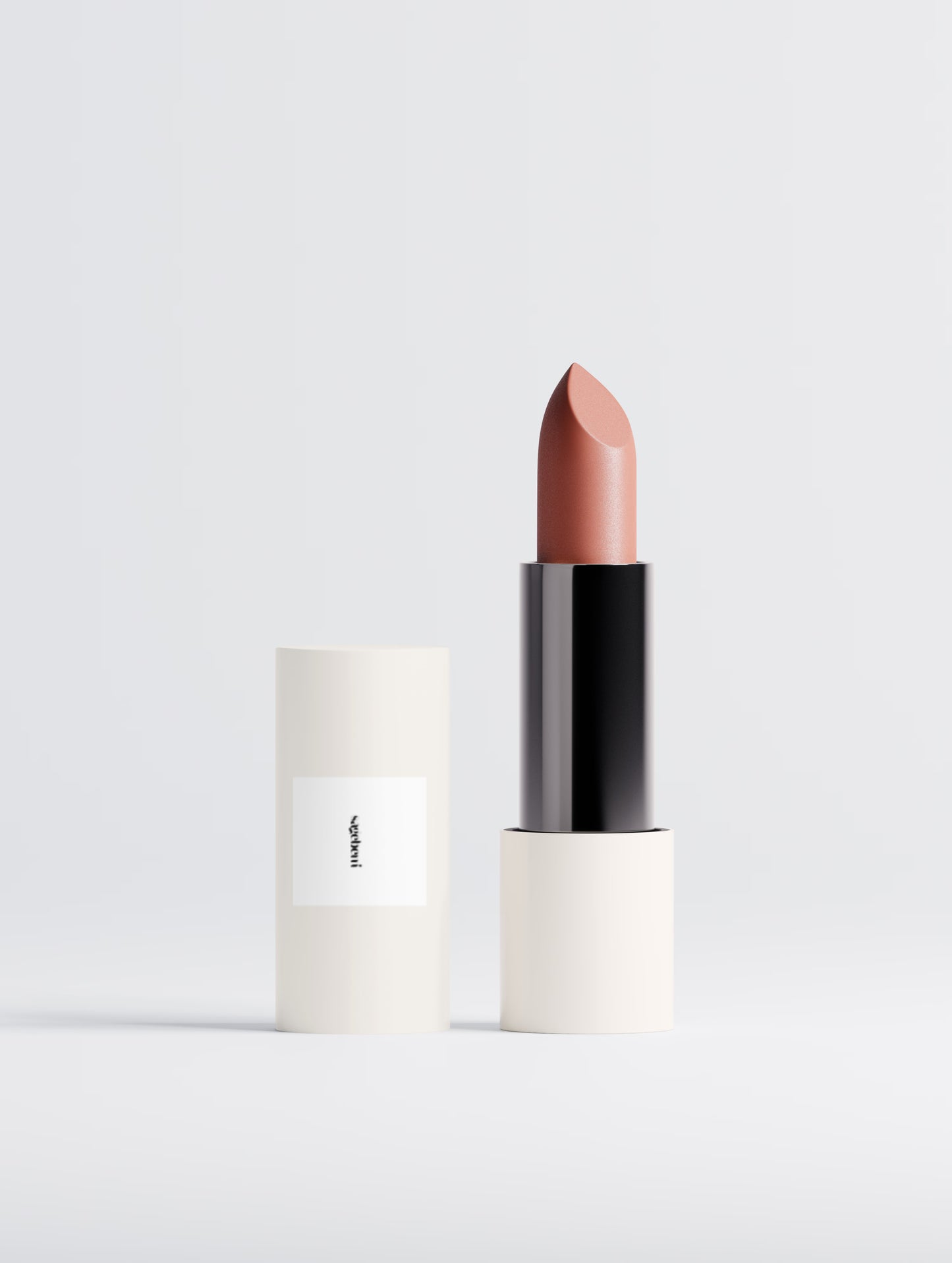 A tube of lipstick standing upright next to its matching carton on a clean white studio background. The lipstick bullet is a muted dusty rose or mauve shade, housed in a black and white tube.