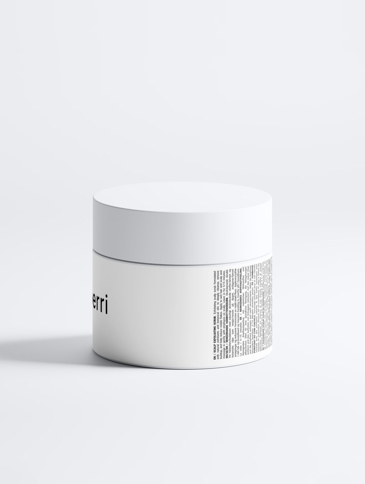 A matte white cosmetic jar with a screw lid sits on a pale grey backdrop, its minimalist label showing partial branding and partial text.