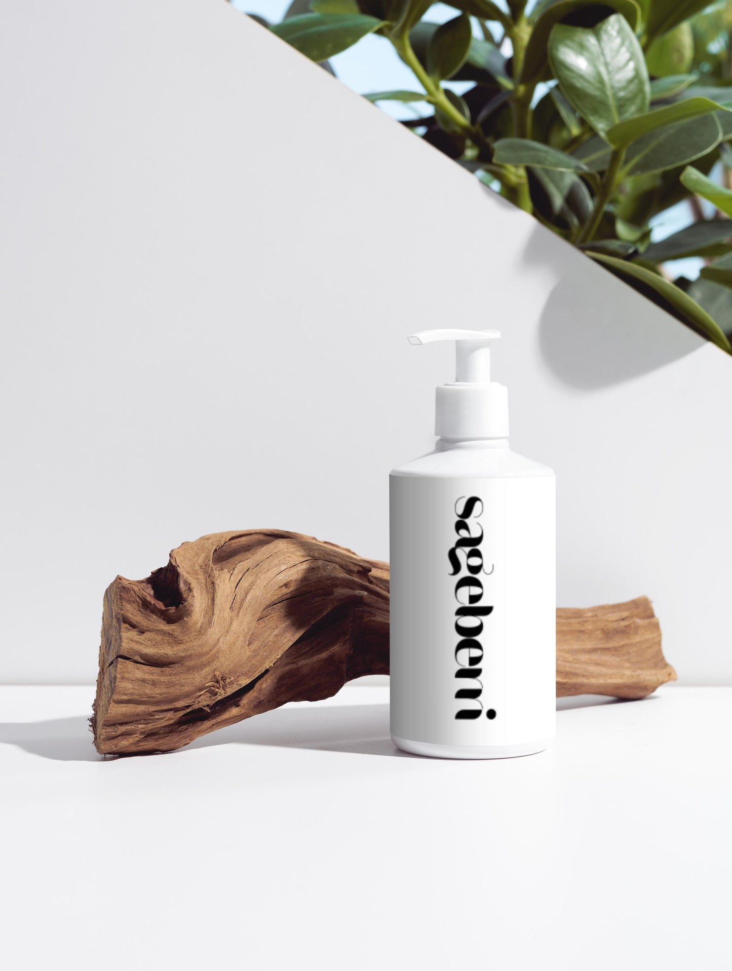 White shampoo bottle with black logo on a white surface with natural elements