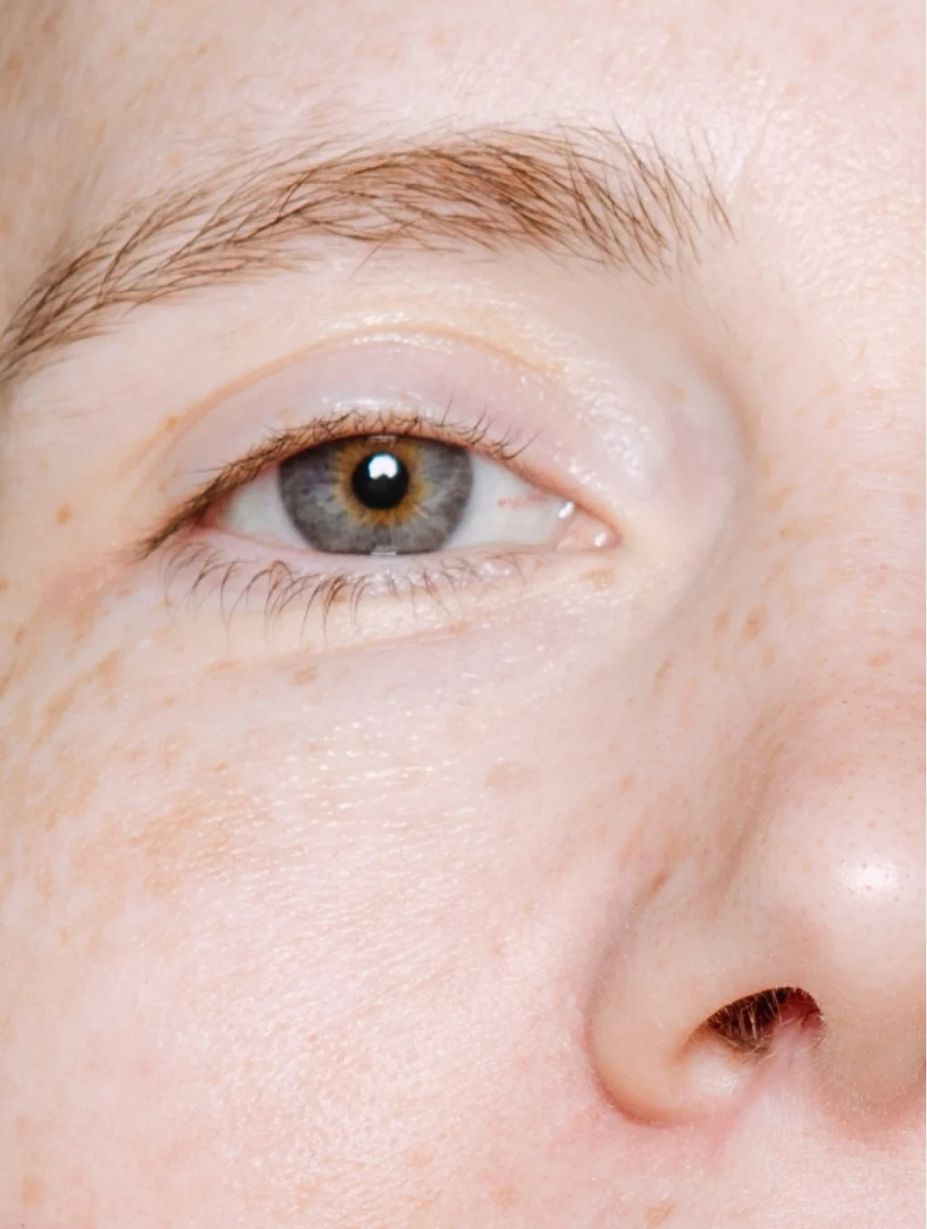 Close-up of a person's eye with a light background